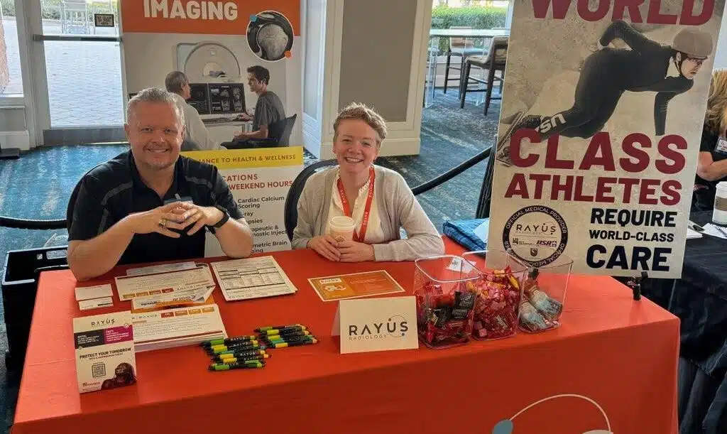 man and woman at rayus branded conference table