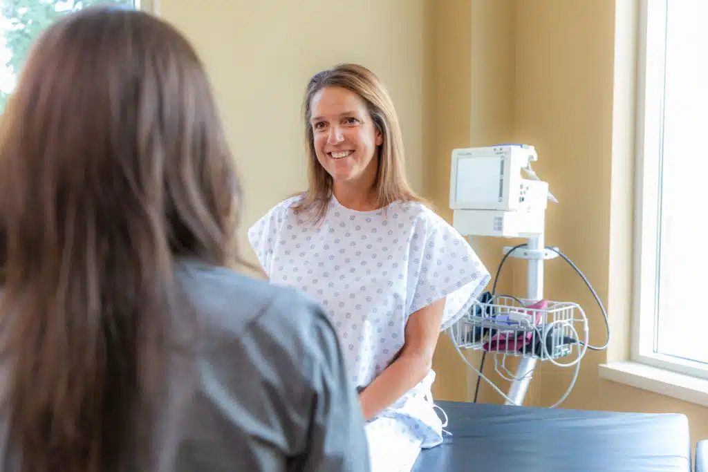 Patient sitting in exam room with nurse